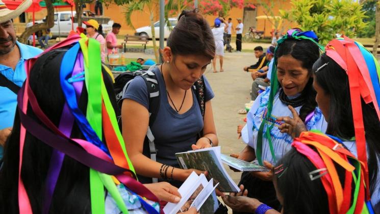 TRABAJO COLABORATIVO. Narel Paniagua y algunas mujeres indígenas Lamas leyendo los libros producidos en conjunto sobre el uso de palmeras.